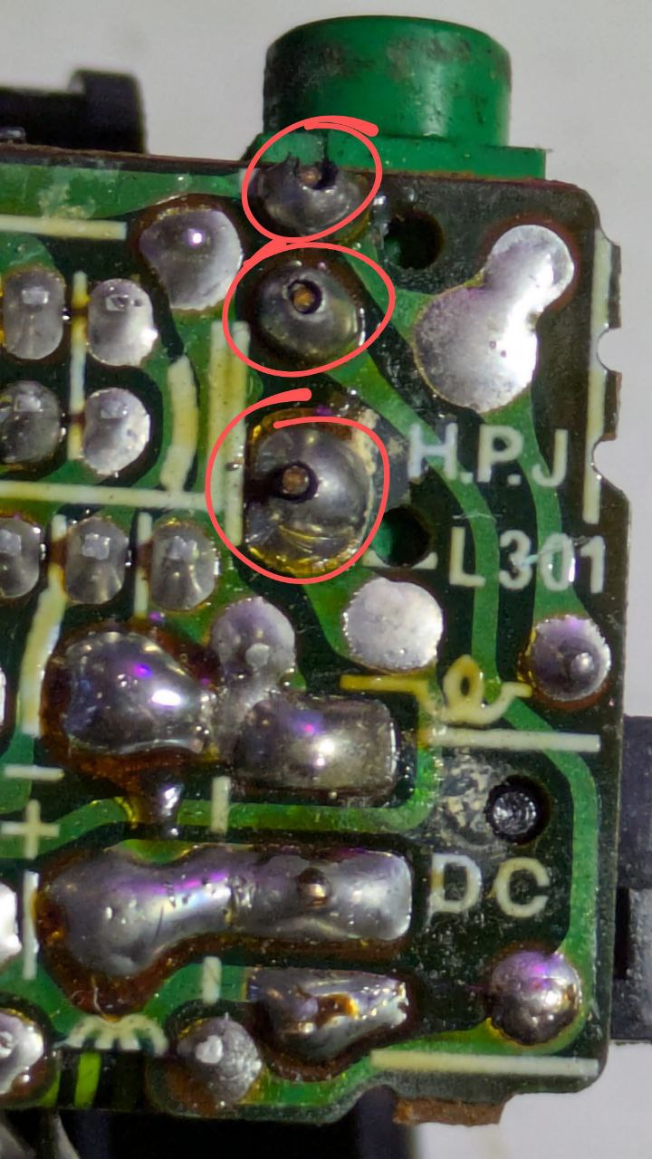 Three pins circled on a circuit board